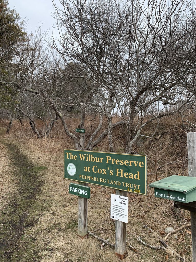 Entrance sign for the Wilbur Preserve at Cox's Head, beside the trail, with a parking sign